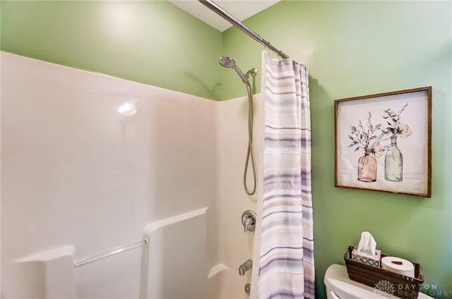 bathroom with toilet and shower / bath combo with shower curtain