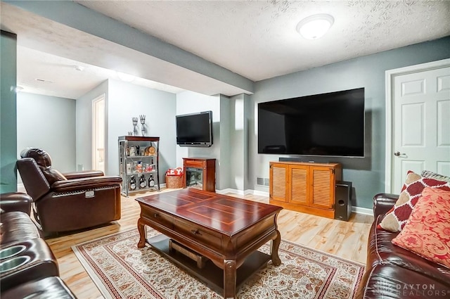 living room featuring hardwood / wood-style flooring and a textured ceiling