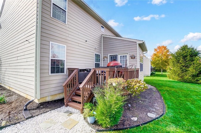 rear view of house with a deck and a lawn