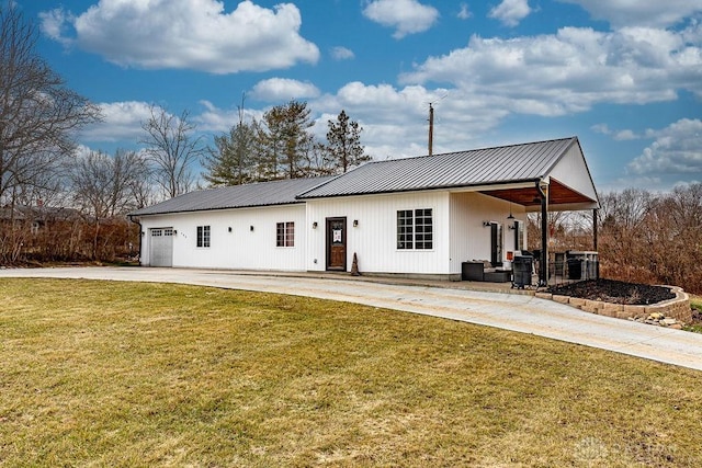 back of house featuring a garage and a yard