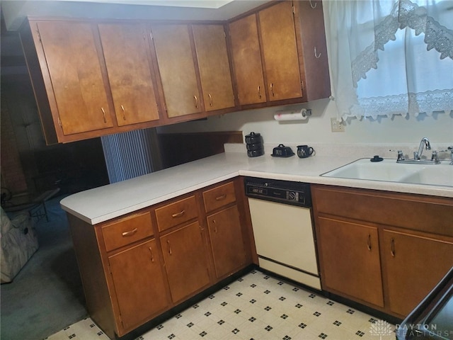 kitchen featuring white dishwasher, kitchen peninsula, and sink