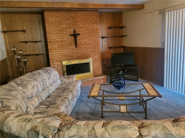 carpeted living room with a brick fireplace and wood walls