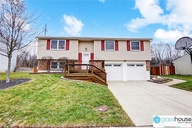 split foyer home featuring a garage and a front yard