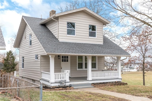 bungalow-style home with a front lawn and a porch