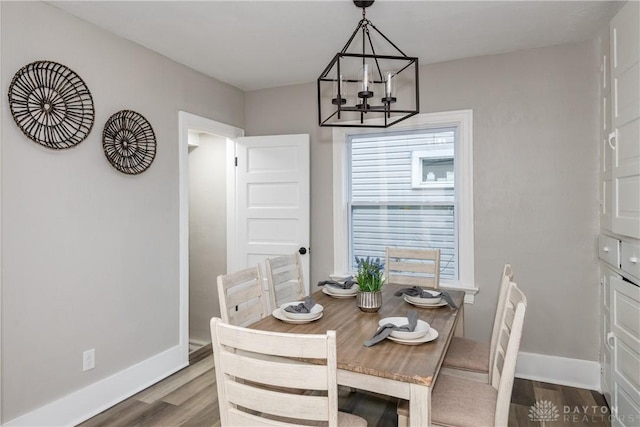 dining room featuring hardwood / wood-style flooring and an inviting chandelier