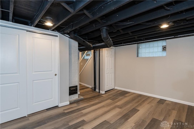 basement with hardwood / wood-style floors