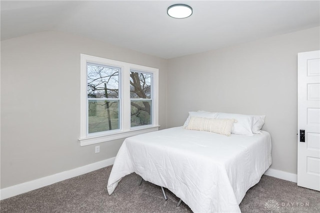 bedroom with lofted ceiling and carpet