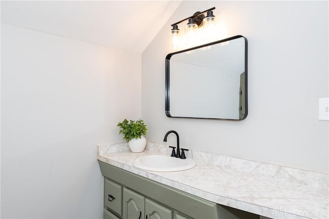 bathroom featuring vanity and lofted ceiling