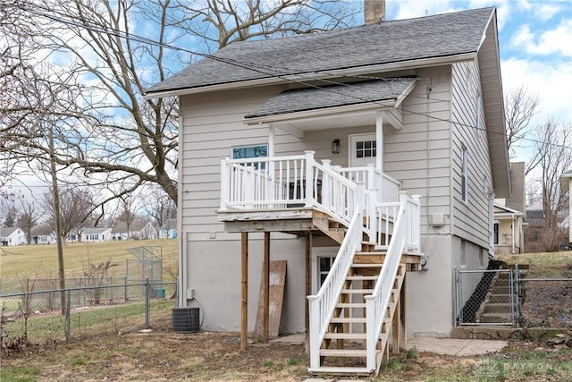 back of property with cooling unit and a deck