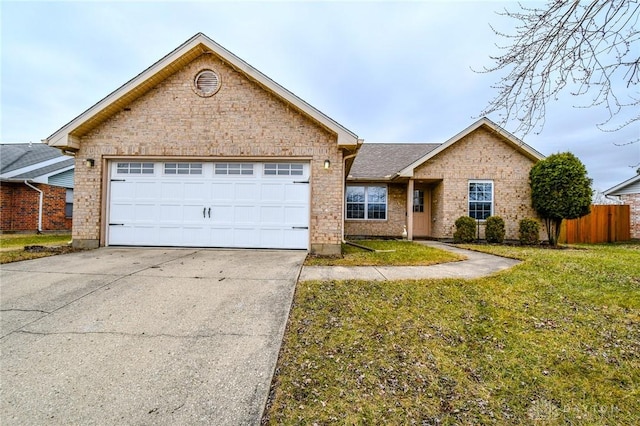 ranch-style house featuring a garage and a front lawn