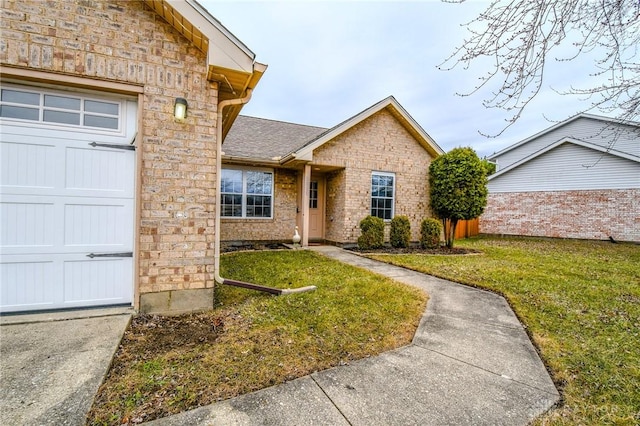 view of front of home featuring a garage and a front lawn