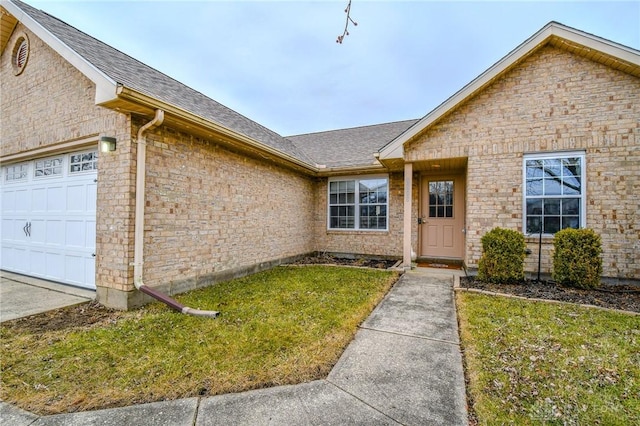 view of front of property with a garage and a front lawn