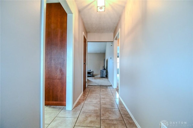 hall with light tile patterned floors