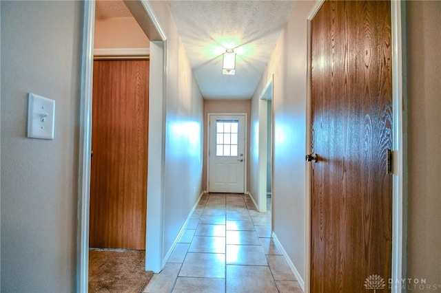 doorway featuring light tile patterned flooring