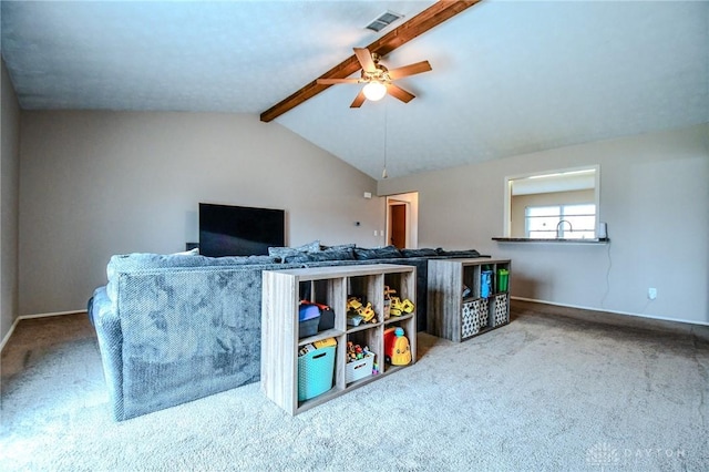 recreation room with ceiling fan, carpet flooring, and lofted ceiling with beams