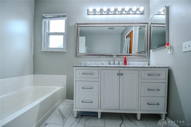 bathroom with vanity and a tub to relax in