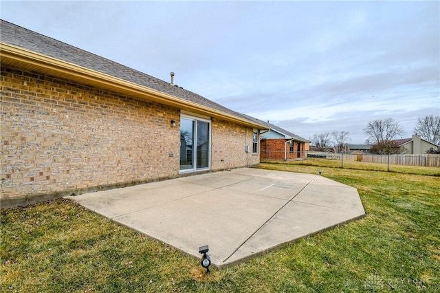 rear view of property with a yard and a patio