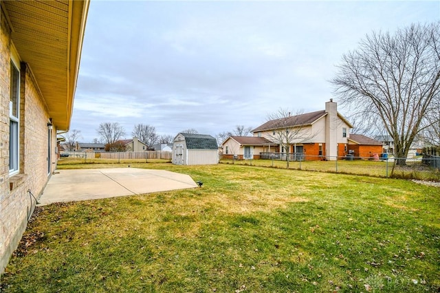 view of yard with a storage unit and a patio