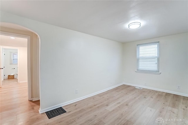 unfurnished room with light wood-type flooring