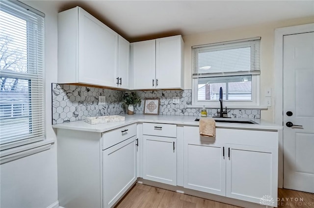 kitchen featuring white cabinetry, a healthy amount of sunlight, and sink