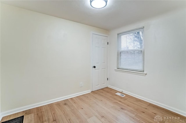 empty room with light hardwood / wood-style flooring