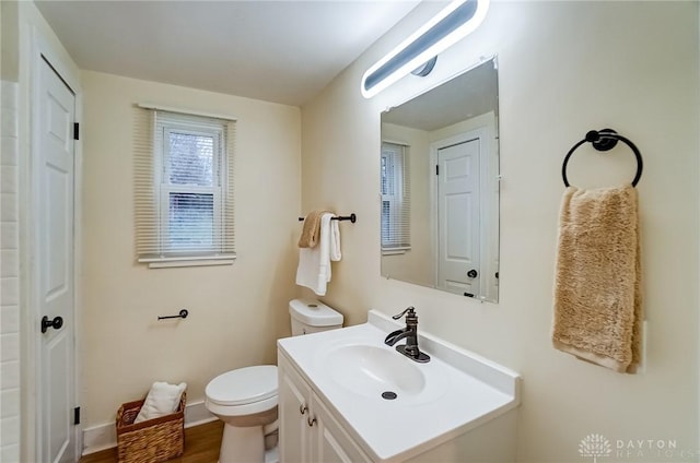 bathroom with vanity, toilet, and wood-type flooring