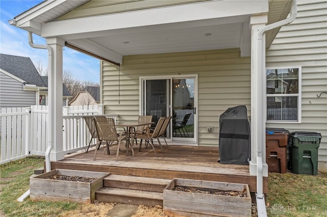 wooden deck with a grill