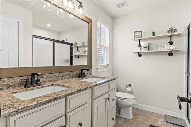 bathroom featuring walk in shower, vanity, toilet, and tile patterned flooring