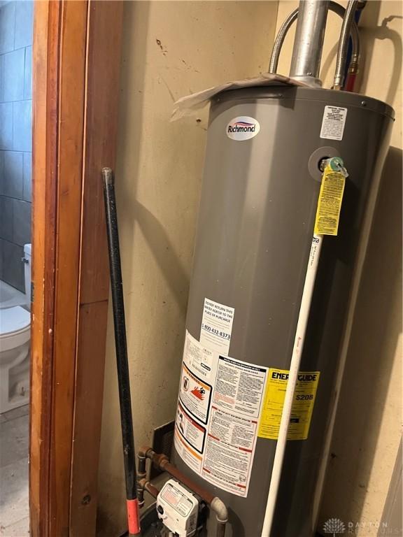 utility room featuring water heater