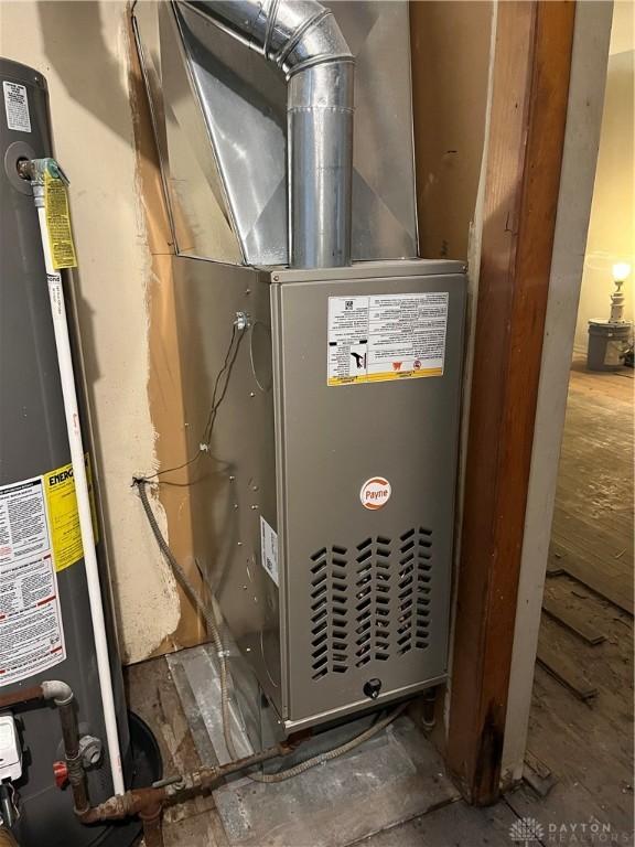 utility room with water heater and heating unit