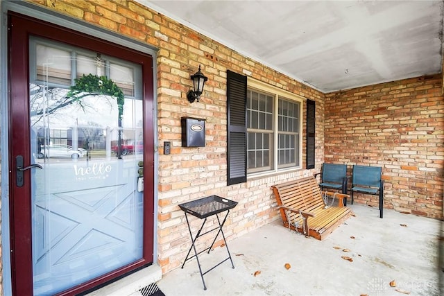 view of exterior entry with a porch