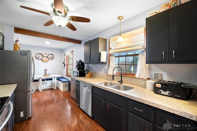 kitchen featuring pendant lighting, sink, ceiling fan, appliances with stainless steel finishes, and dark hardwood / wood-style floors