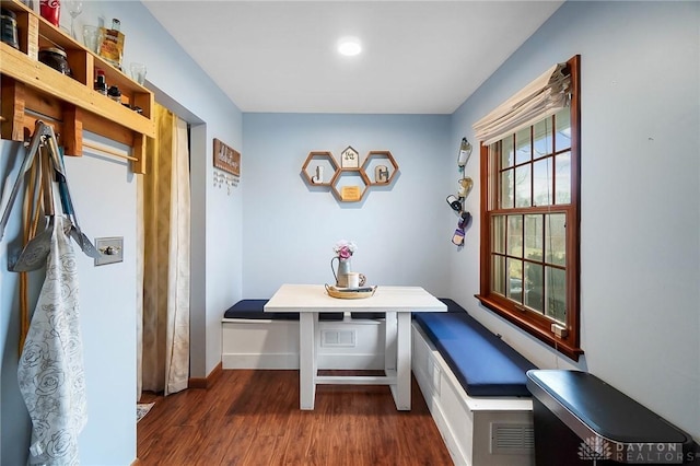 dining area featuring breakfast area and dark hardwood / wood-style flooring