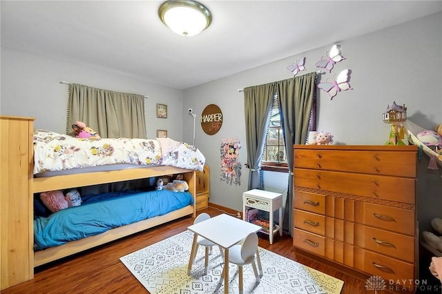 bedroom with dark hardwood / wood-style flooring