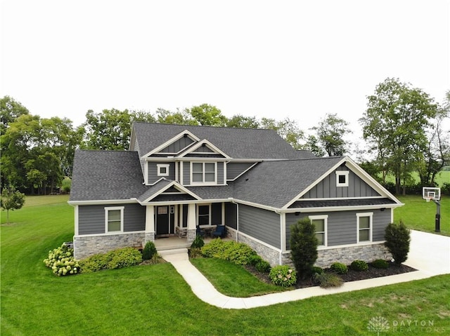 craftsman house with covered porch and a front yard