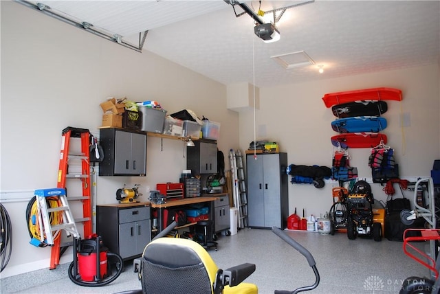 garage featuring a garage door opener and a workshop area