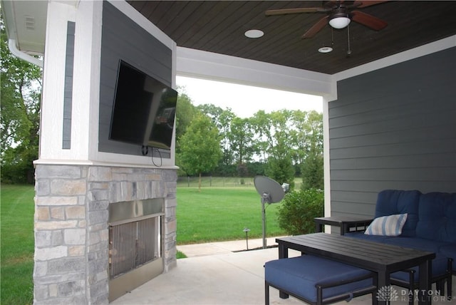 view of patio featuring ceiling fan and an outdoor stone fireplace