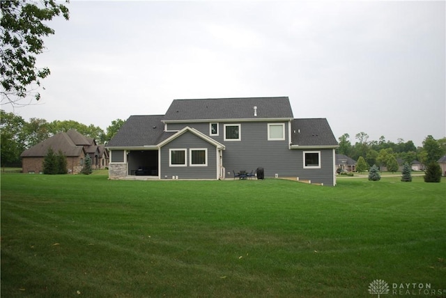 back of house featuring a patio and a lawn