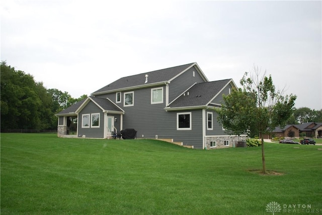 rear view of house featuring a lawn