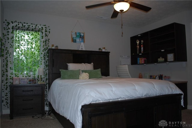 bedroom with ceiling fan and carpet flooring