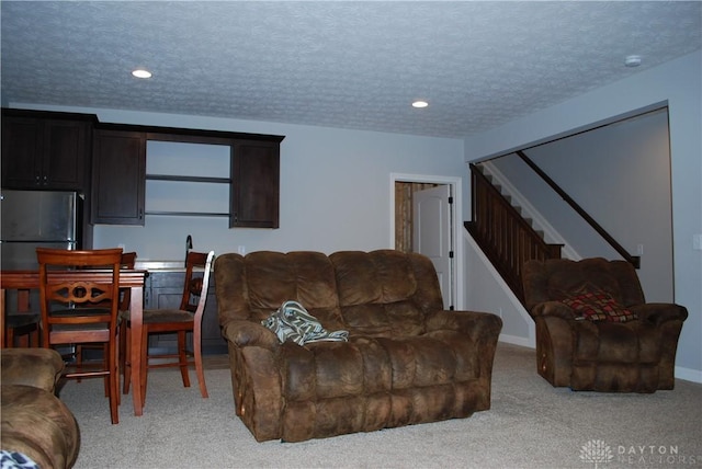 living room with light carpet and a textured ceiling