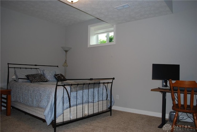 carpeted bedroom with a textured ceiling