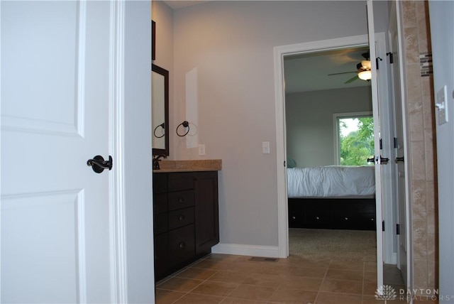 bathroom featuring tile patterned flooring, vanity, and ceiling fan