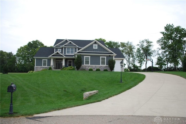 craftsman house with a garage and a front yard