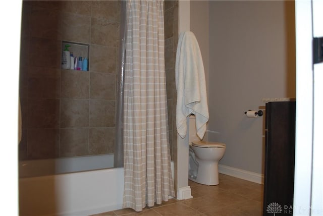 bathroom with shower / tub combo with curtain, tile patterned floors, and toilet