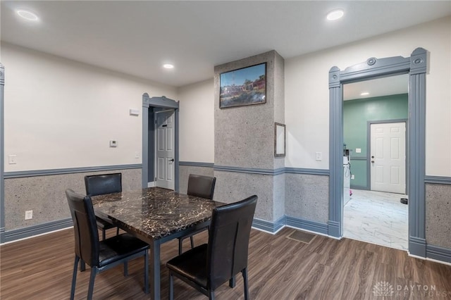 dining space with dark hardwood / wood-style flooring