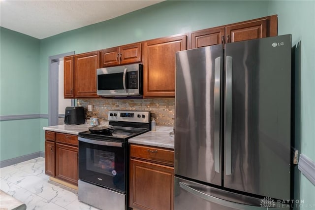 kitchen with tasteful backsplash and appliances with stainless steel finishes