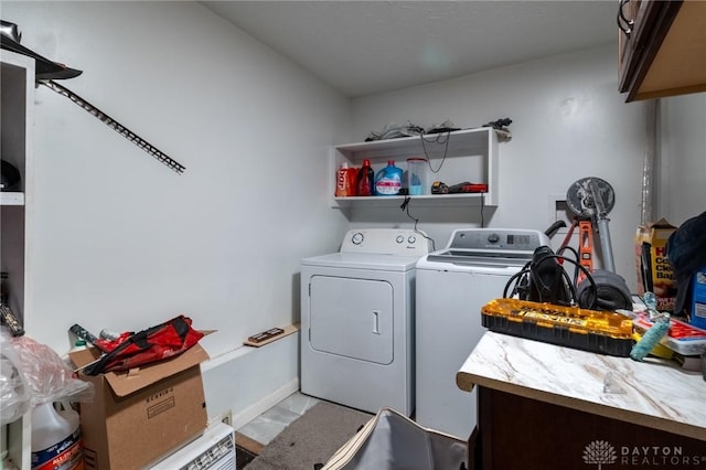 laundry area featuring cabinets and washing machine and clothes dryer