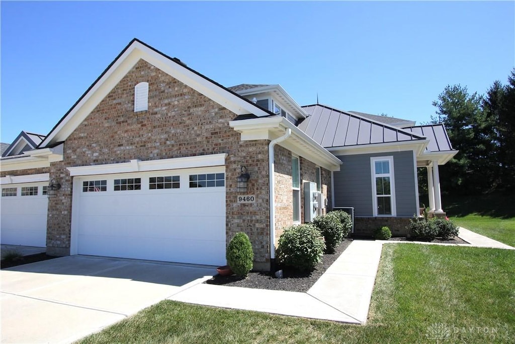 view of front of property featuring a garage and a front yard