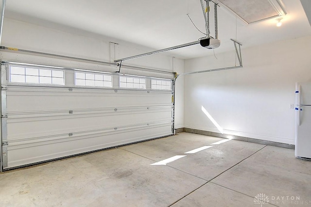 9460 Banyan Ct, Centerville, OH 45458 - garage with a garage door opener, freestanding refrigerator, and baseboards